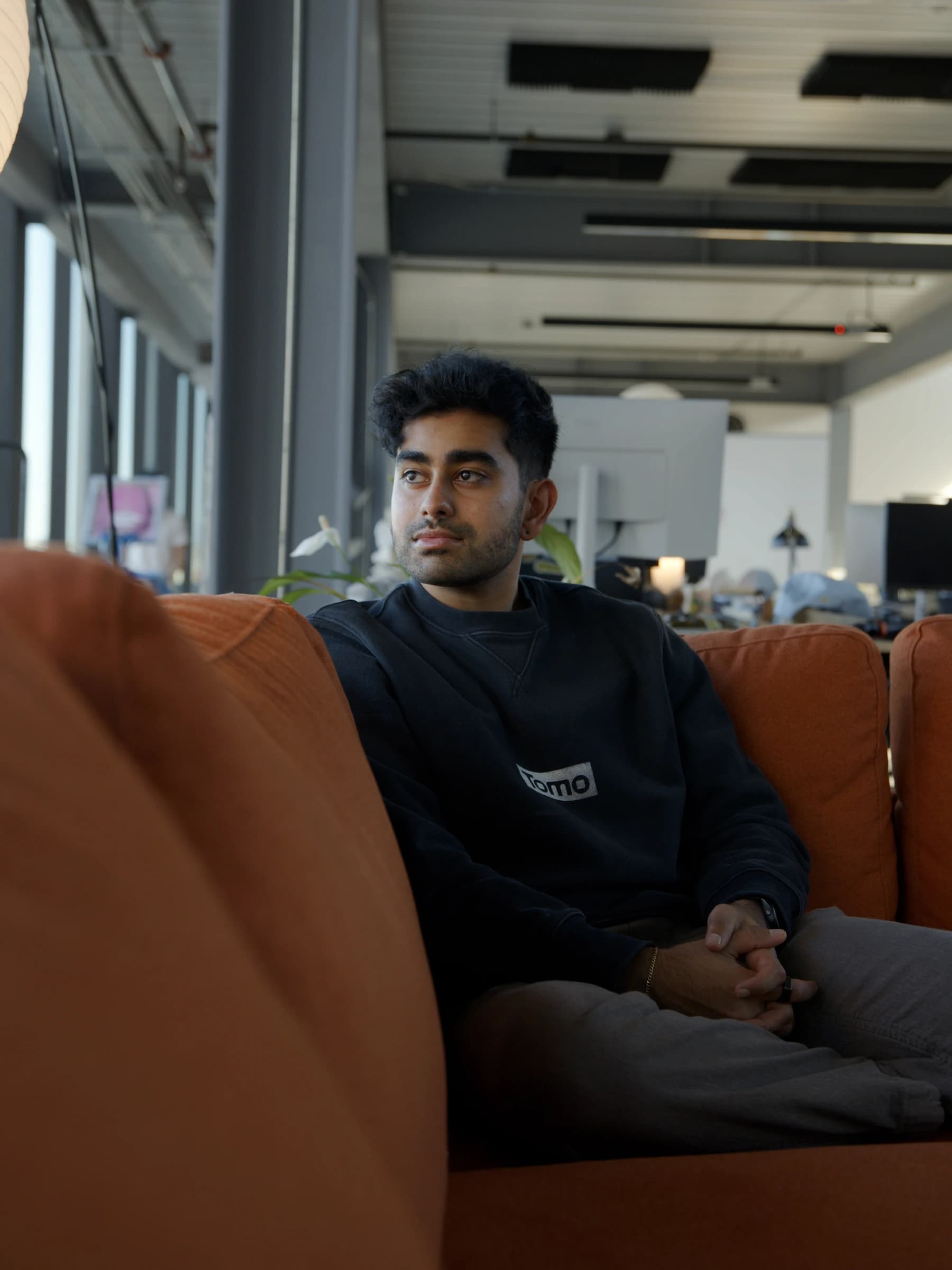 Team member on the orange couch