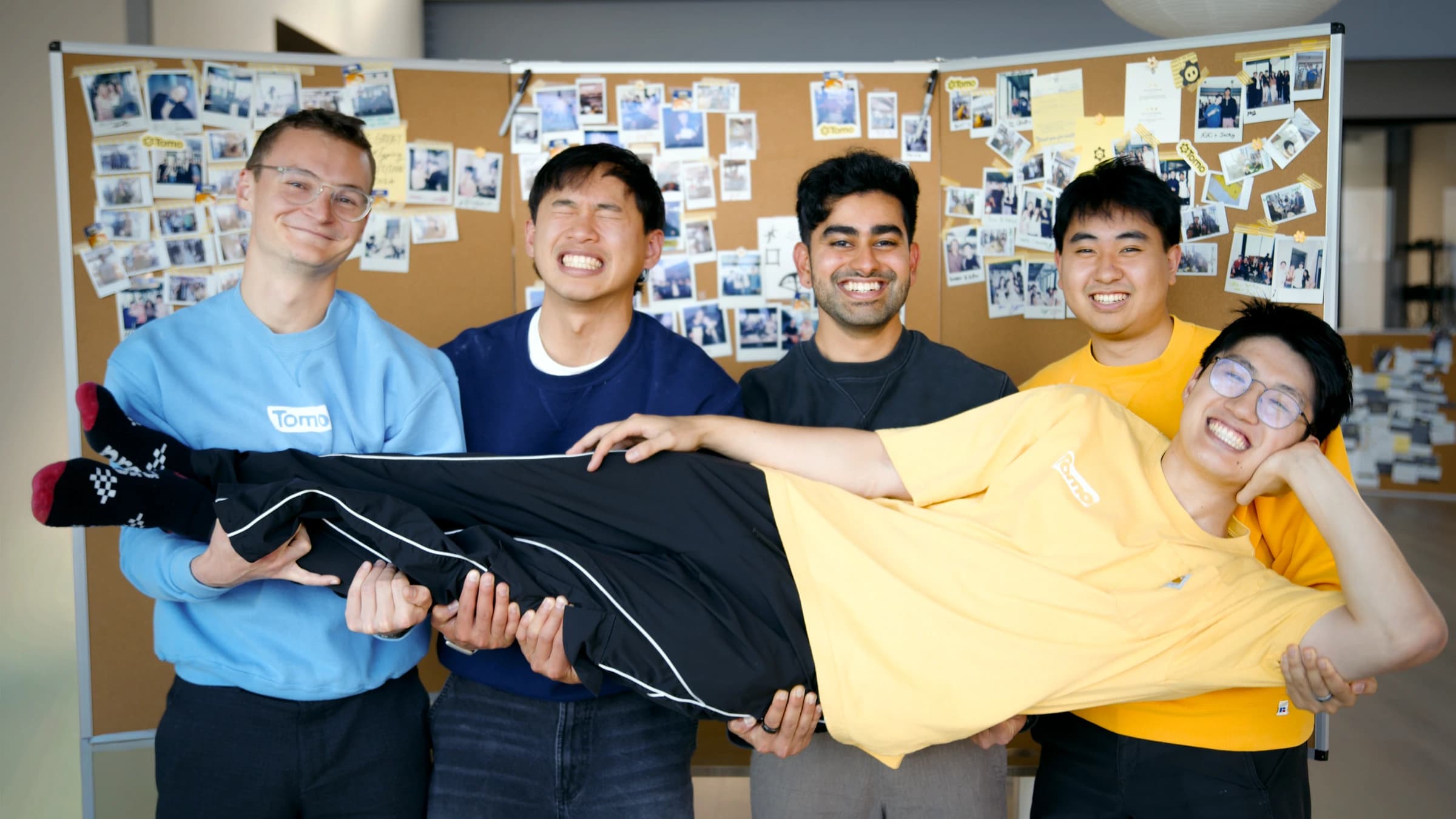 Team lifted in front of the corkboard