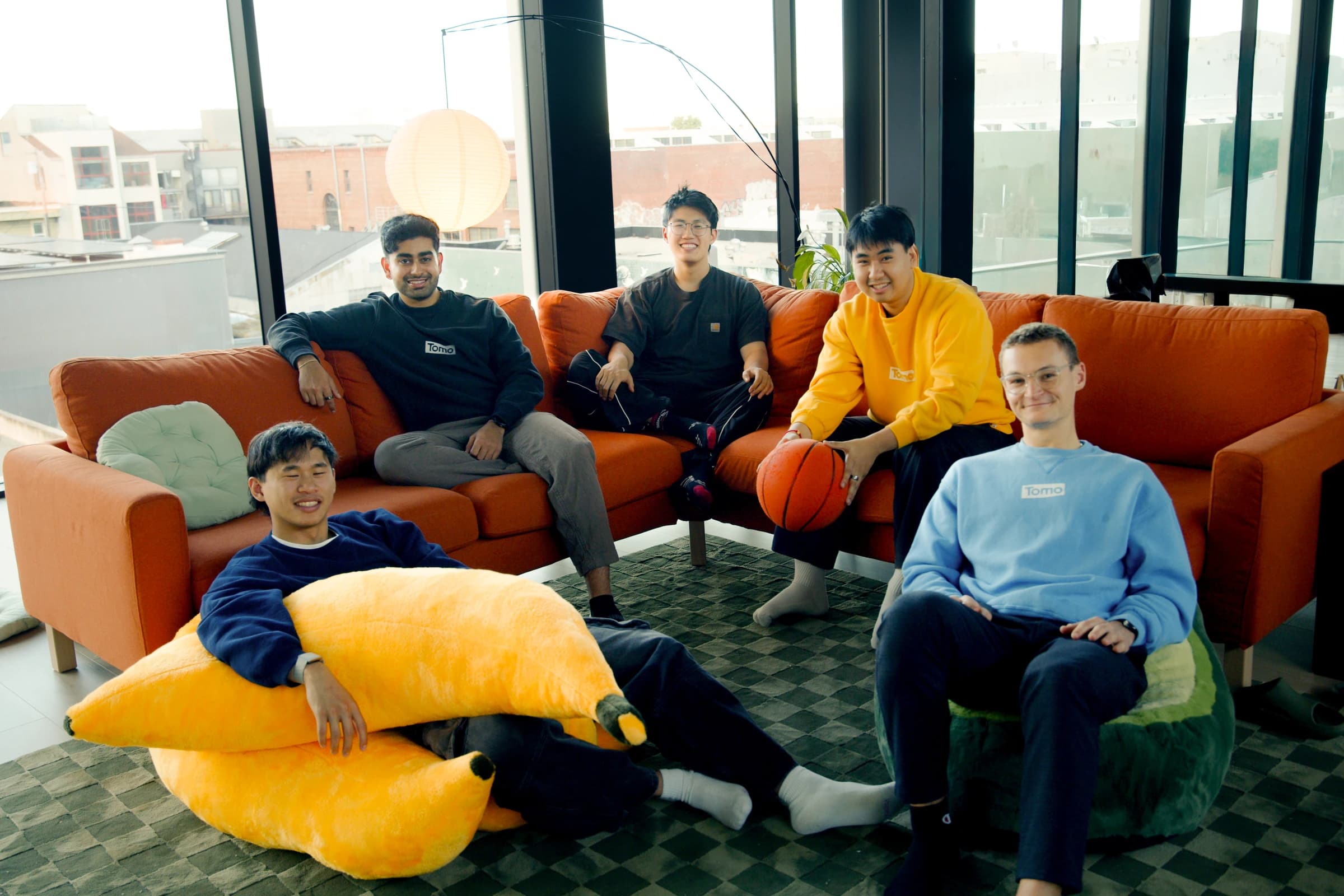 Tomo team on the orange sofa